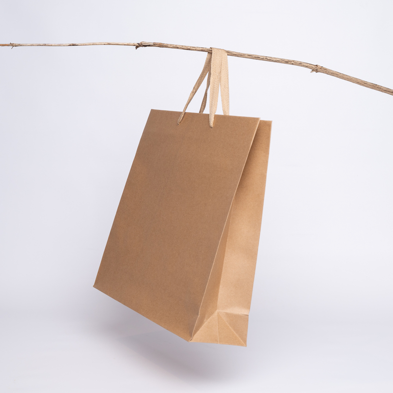 This picture shows a natural colored kraft paper bag. This kraft tote bag is a very practical packaging solution.